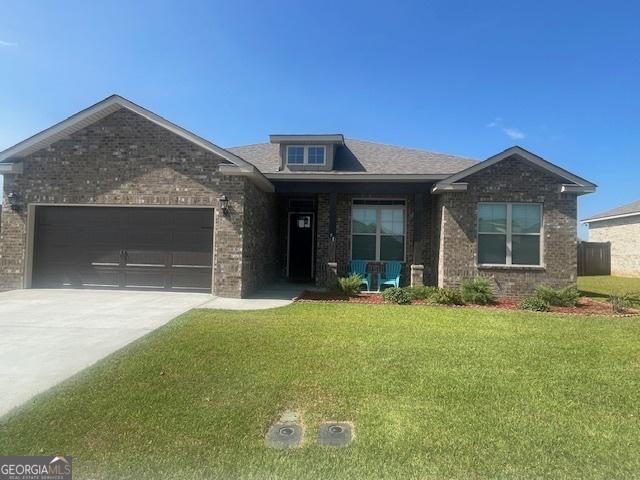 view of front of house with a front lawn and a garage