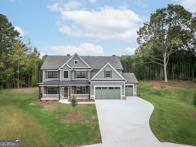 craftsman house featuring a front lawn, covered porch, and a garage