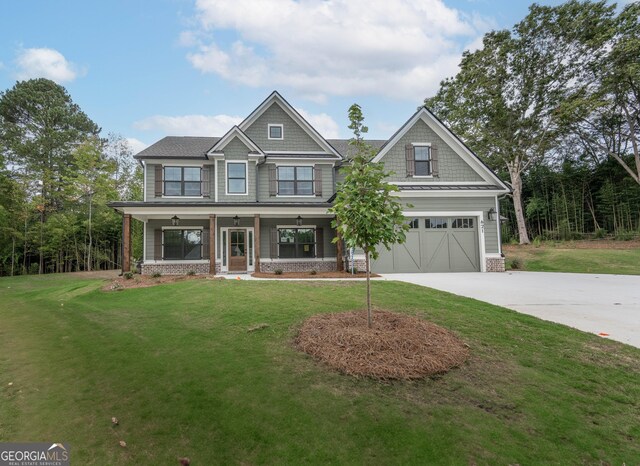 craftsman-style home featuring a front lawn, covered porch, and a garage