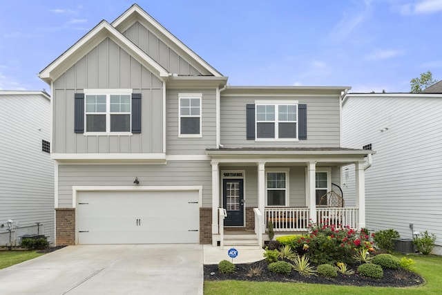 craftsman-style house with central AC unit, a porch, and a garage