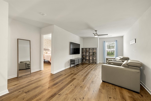 living room with ceiling fan and light hardwood / wood-style floors