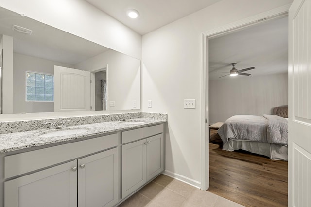 bathroom featuring hardwood / wood-style floors, vanity, and ceiling fan