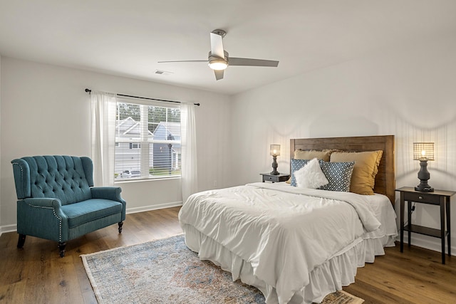 bedroom with ceiling fan and hardwood / wood-style flooring