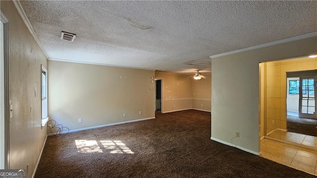 unfurnished room featuring a textured ceiling, carpet floors, and crown molding