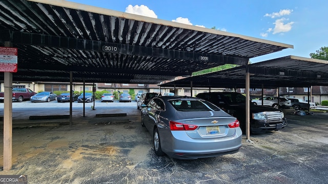 view of parking / parking lot featuring a carport