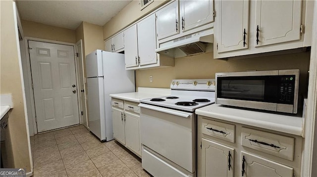 kitchen with white cabinetry, white appliances, and light tile patterned floors