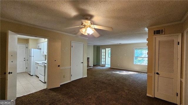 spare room with a textured ceiling, ceiling fan, ornamental molding, and light carpet