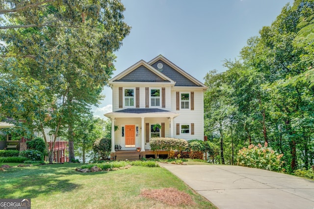 view of front of home with a front yard and a porch