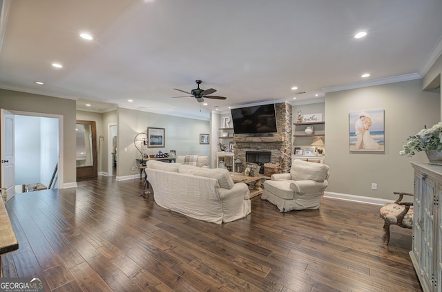 living room featuring crown molding, ceiling fan, dark hardwood / wood-style flooring, and a fireplace