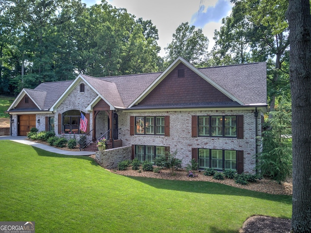 craftsman-style house featuring a garage and a front lawn