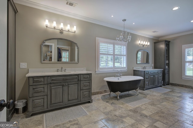 bathroom with a bathing tub, vanity, ornamental molding, and a chandelier