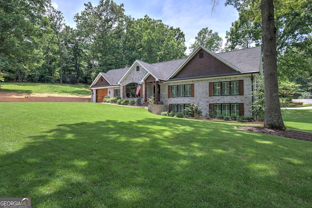 view of front of property with a front yard and a garage