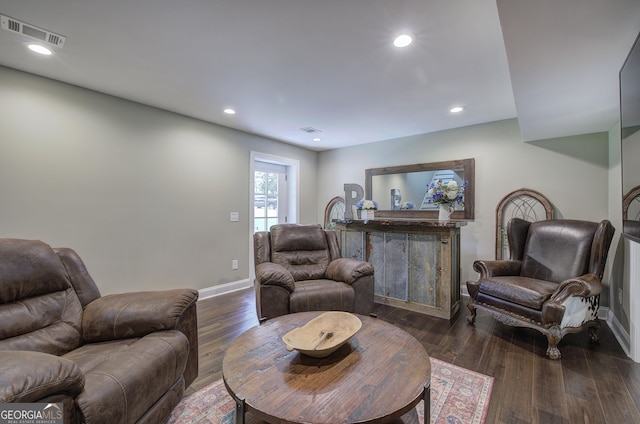 living room with dark hardwood / wood-style flooring