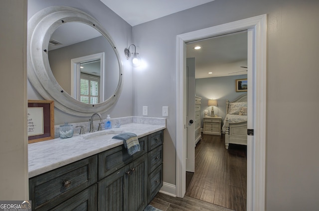 bathroom with vanity, ceiling fan, and wood-type flooring