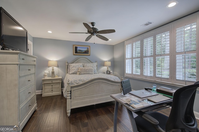 bedroom featuring dark hardwood / wood-style floors, ceiling fan, and multiple windows