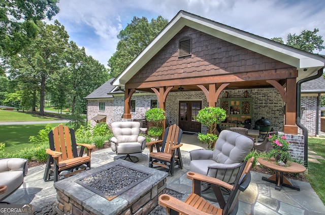 view of patio featuring an outdoor living space with a fire pit