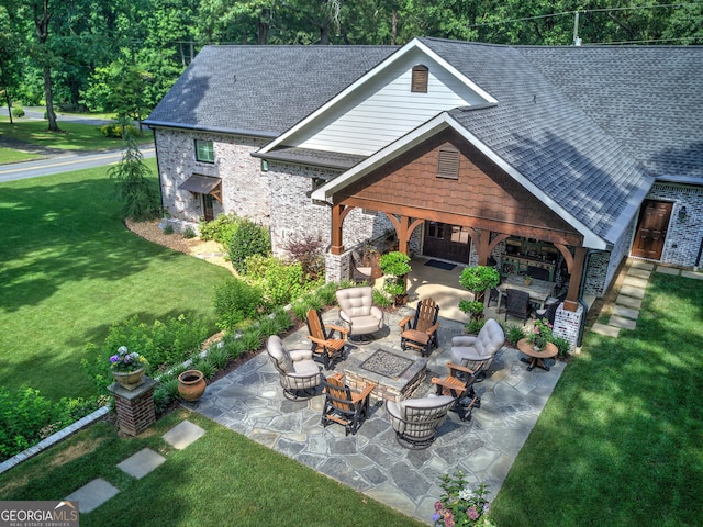 view of patio with an outdoor living space with a fire pit