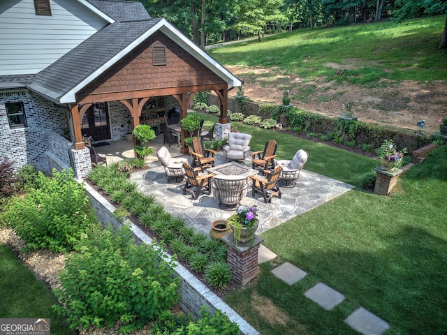 view of yard with a fire pit and a patio area