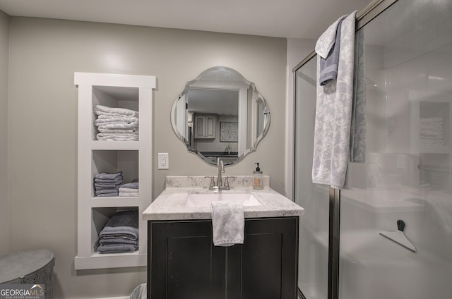 bathroom featuring vanity and a shower with shower door