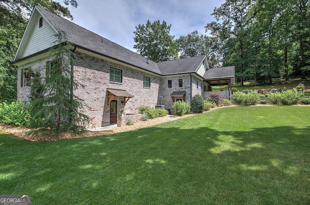 view of side of home featuring a yard