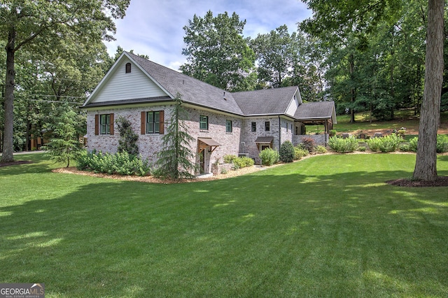 view of side of home with a yard