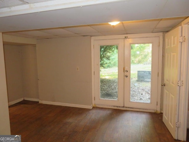 entryway featuring french doors, dark wood-type flooring, and a drop ceiling