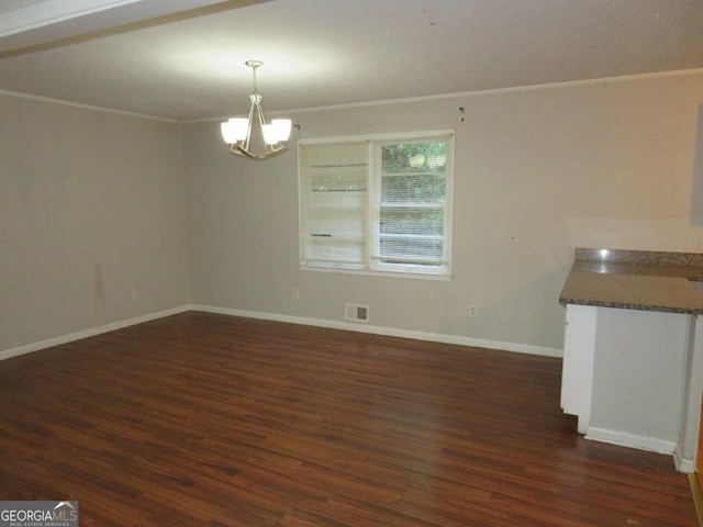 unfurnished dining area featuring a chandelier, dark hardwood / wood-style flooring, and crown molding