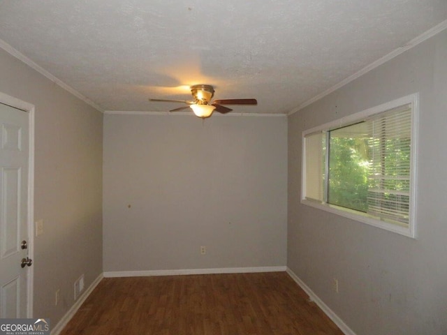 spare room featuring a textured ceiling, crown molding, and dark hardwood / wood-style floors