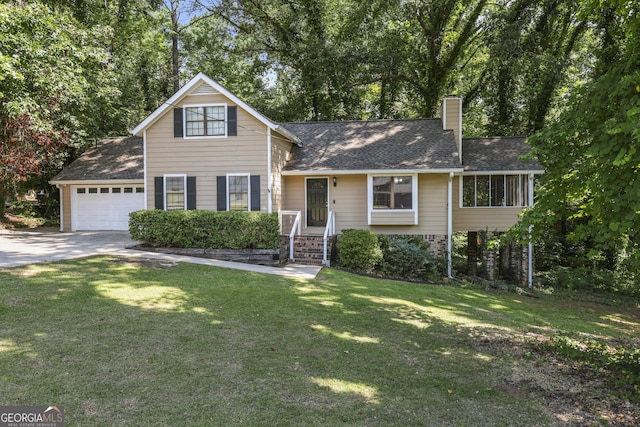 view of front of home with a front yard and a garage