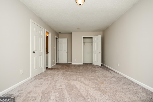 unfurnished bedroom featuring light colored carpet and a textured ceiling