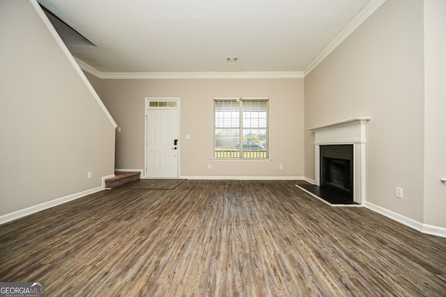 unfurnished living room featuring crown molding and dark wood-type flooring