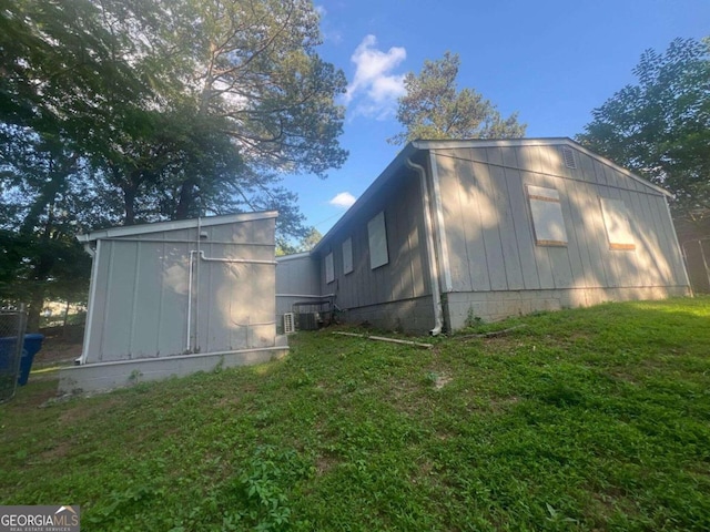 view of home's exterior featuring a lawn and cooling unit