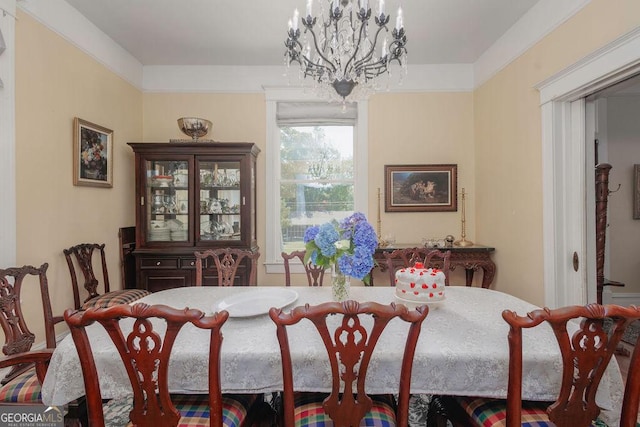 dining space featuring crown molding and an inviting chandelier