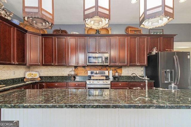 kitchen featuring backsplash, stainless steel appliances, and dark stone counters