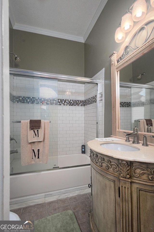 bathroom with combined bath / shower with glass door, vanity, tile patterned floors, and crown molding