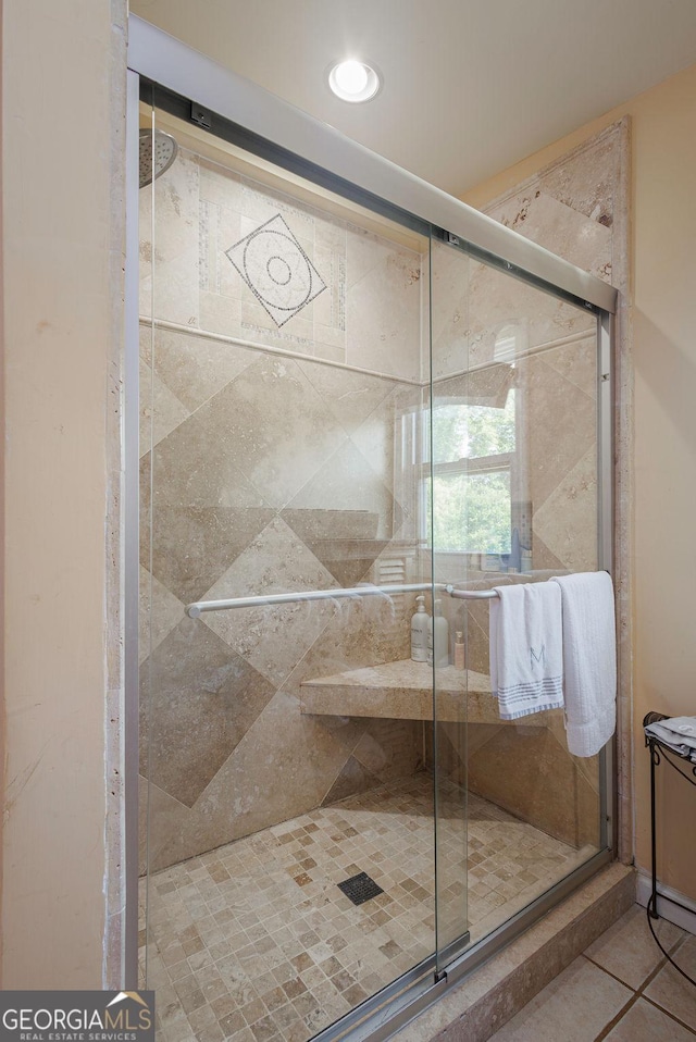 bathroom with tile patterned flooring and an enclosed shower