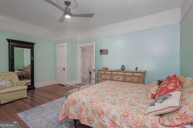 bedroom with dark hardwood / wood-style floors and ceiling fan