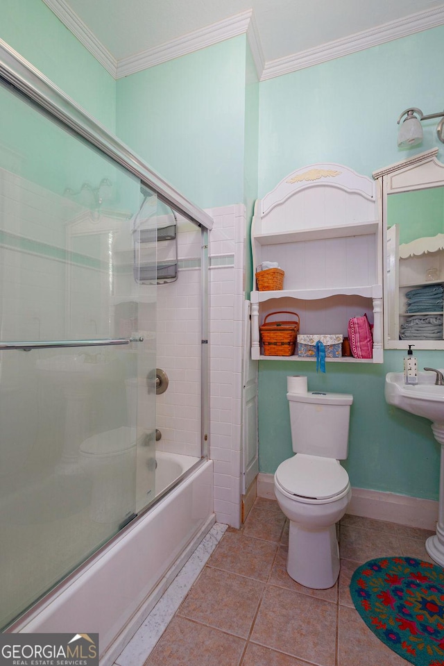 bathroom with tile patterned floors, enclosed tub / shower combo, toilet, and ornamental molding