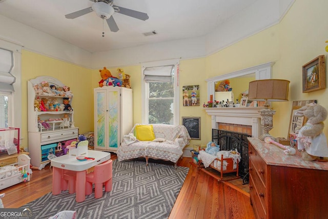 recreation room with ceiling fan and hardwood / wood-style floors