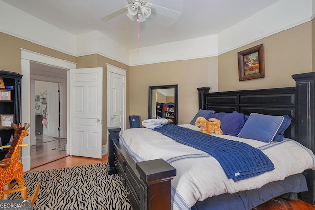 bedroom featuring wood-type flooring, a closet, and ceiling fan