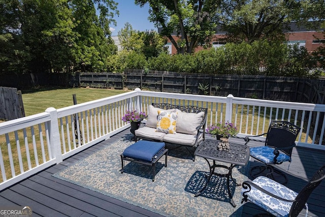 deck with outdoor lounge area and a yard