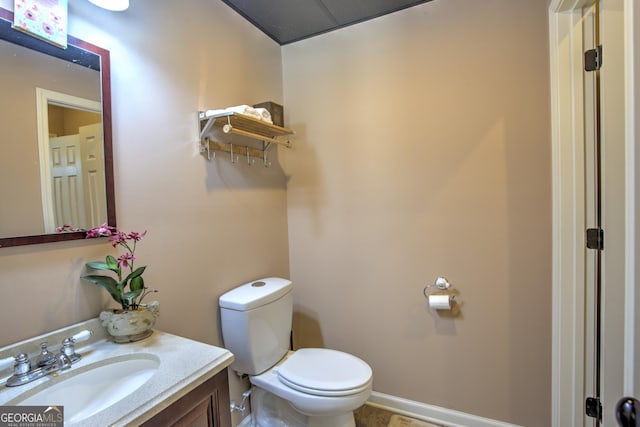 bathroom featuring toilet and vanity