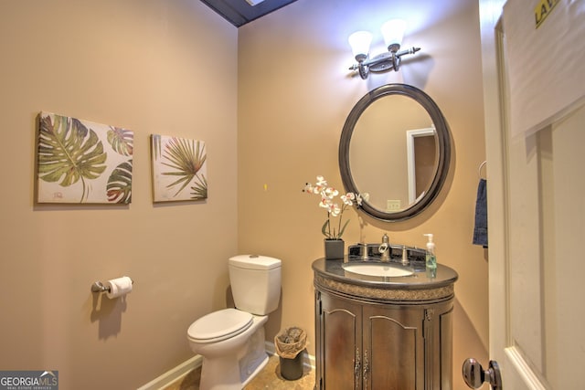 bathroom featuring toilet and vanity