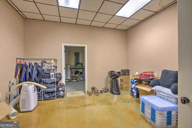 interior space with a drop ceiling and concrete flooring