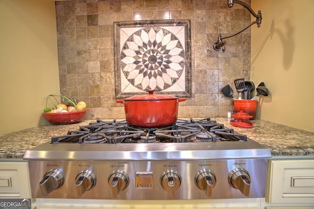 interior details with light stone counters, white cabinets, tasteful backsplash, and stainless steel gas cooktop