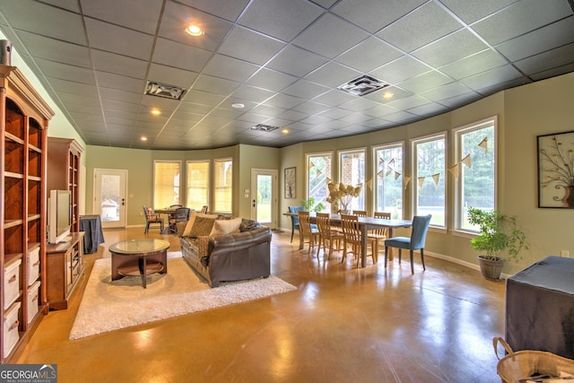 living room with a drop ceiling