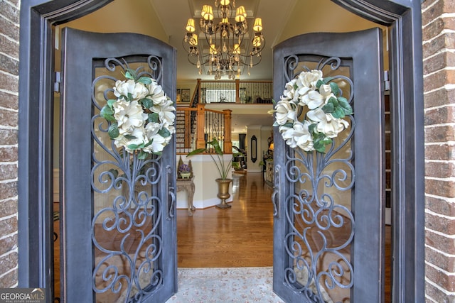 foyer entrance featuring hardwood / wood-style flooring and a chandelier