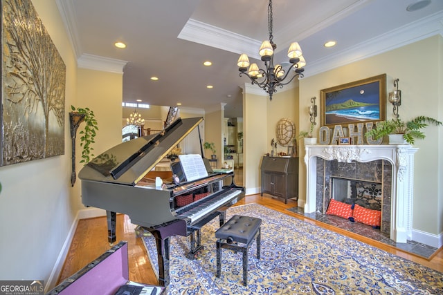 misc room featuring hardwood / wood-style floors, a high end fireplace, crown molding, and a chandelier