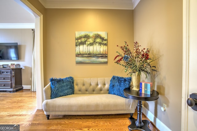 sitting room featuring hardwood / wood-style floors and ornamental molding