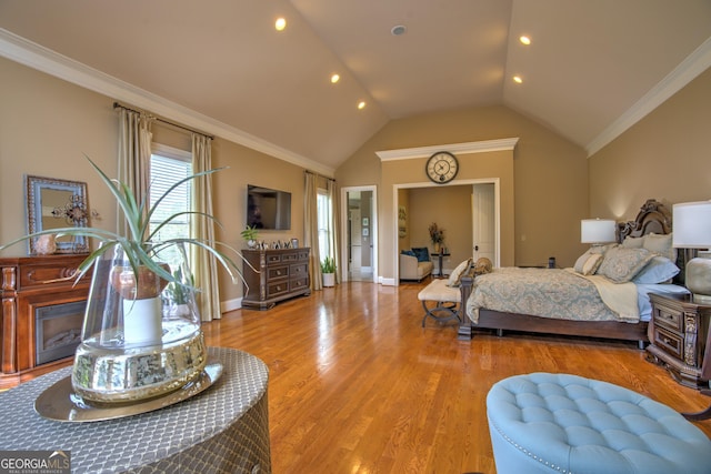 bedroom featuring light hardwood / wood-style floors, vaulted ceiling, and ornamental molding